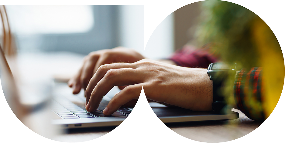 Close-up of a person’s hands typing on a laptop keyboard, wearing a smartwatch and a checked shirt, framed in an overlapping double-circle shape.