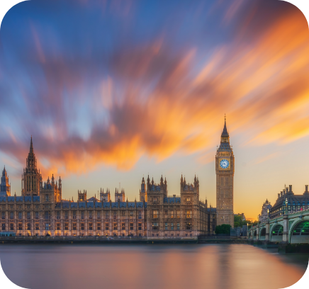 The Houses of Parliament with Big Ben at sunset, with colourful clouds over the river.